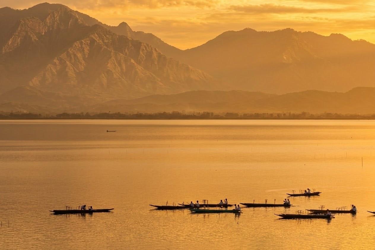 Hazy Lake with Fishermen boats at dawn